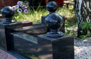 Деталь памятника: ограда из чёрного гранита с шарами